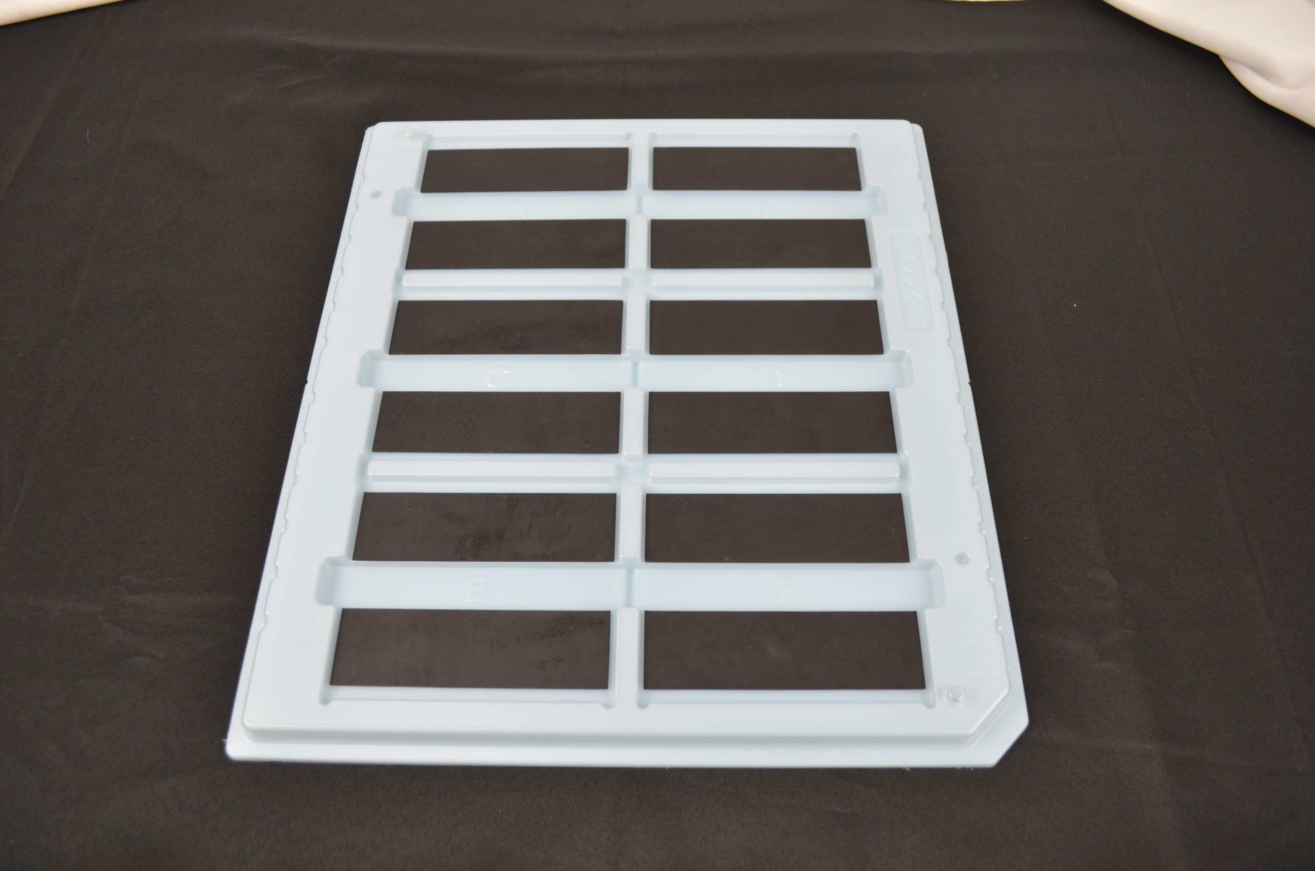 Thermoformed inherently dissipative tray with high temp inserts
